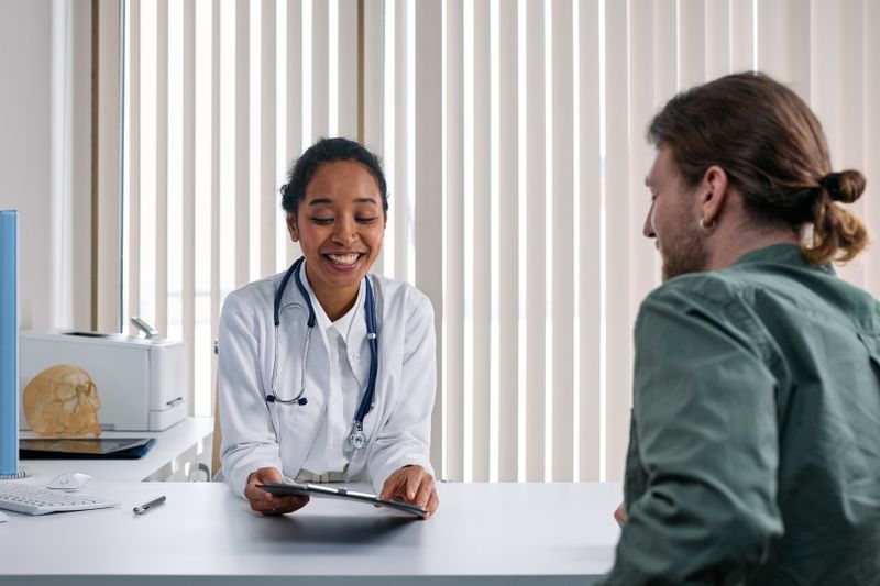A clinician talking with a person across a desk