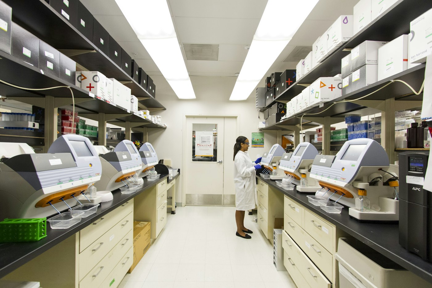 A researcher looking through a microscope